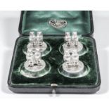 A set of four Edward VII silver menu holders, each in the form of a pair of owls resting on a