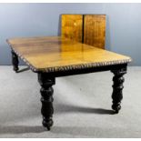 A late Victorian oak rectangular extending dining table with four extra leaves for same, with carved