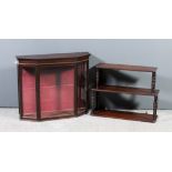 A mahogany three tier open front wall shelf with rounded front corners, reeded edge to each tier, on