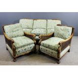 A 1930's walnut framed three piece Bergere suite, the arched backs with solid splats and reeded