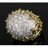 A modern gold and silvery coloured metal mounted all diamond set bombe pattern ring, the oval face