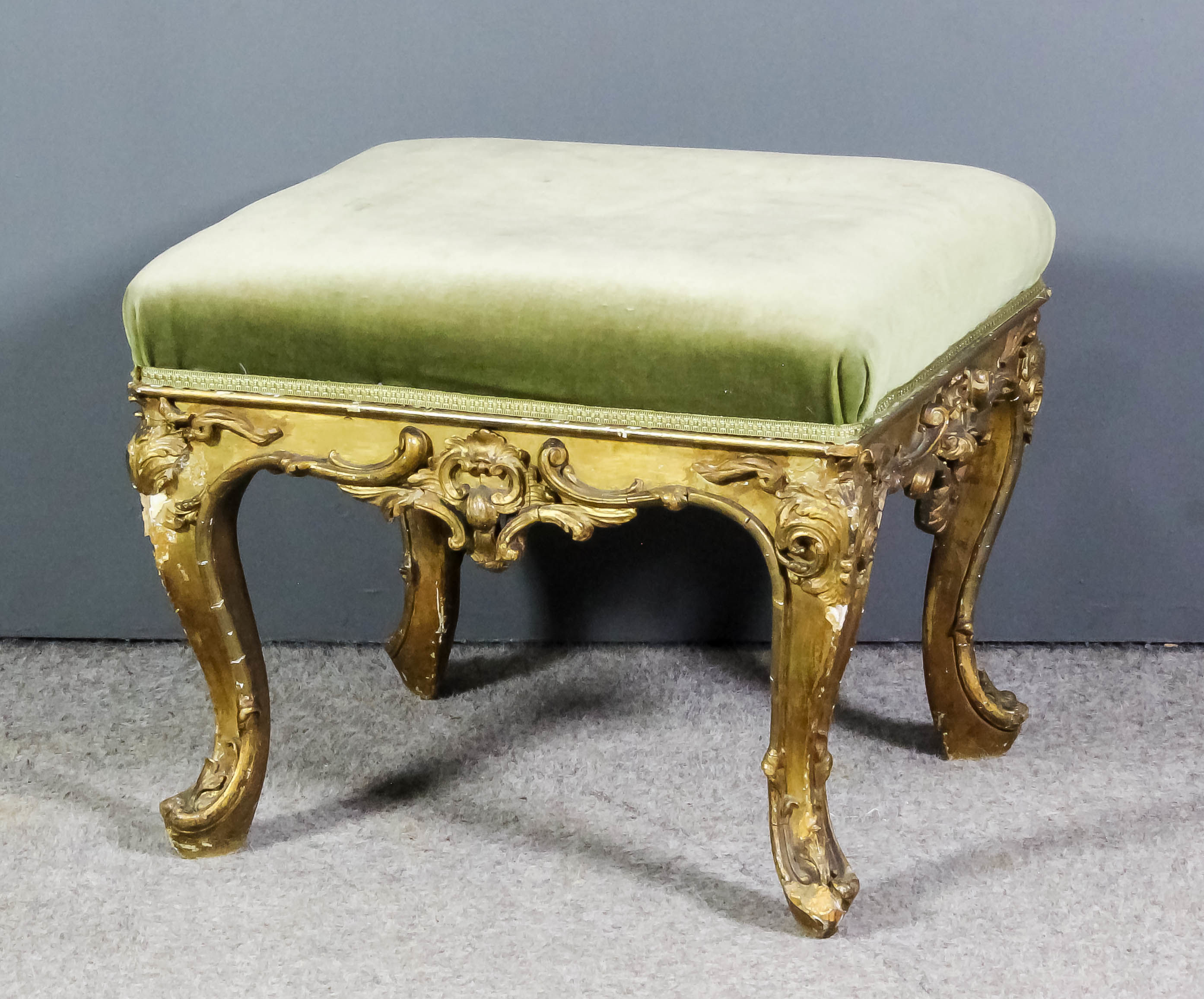 A French gilt framed rectangular stool of Louis XV design, upholstered in green dralon, the rails