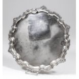 An Elizabeth II silver circular salver, the moulded pie-crust rim with cast shell and floral mounts,