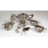 A George V silver oval teapot of panelled form, with shaped rim, wooden finial and angular handle