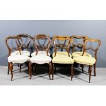 A set of four Victorian rosewood drawing room chairs with shaped backs, moulded scroll splats, seats