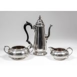 An Edward VII silver cylindrical coffee pot of tapered form and 18th Century design, the domed lid