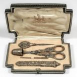 An early 20th Century French silver gilt sewing etui, comprising - needle case embossed with