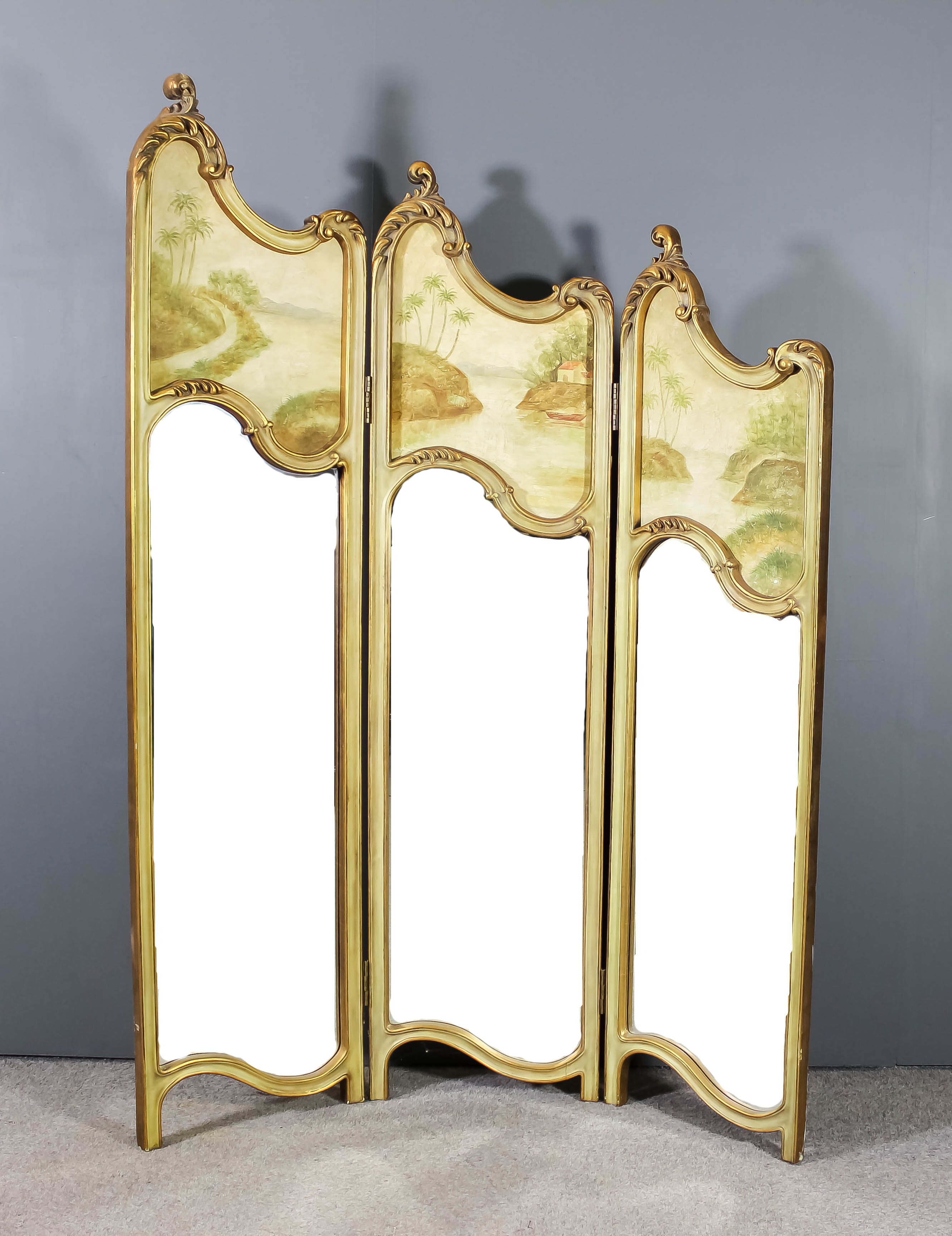 An early 20th Century French gilt and cream painted three fold draught screen of Louis XV design,