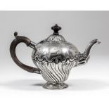 An 18th Century silver teapot of baluster shape, the domed cover and body embossed with spiral