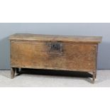 A 17th Century oak plank coffer, the lid with moulded ornament to front and back, 40ins wide x 12.