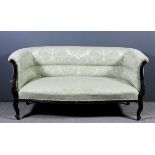 An early 20th Century mahogany framed two seat settee of small proportions, upholstered in green and