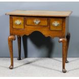 A George III oak lowboy with moulded edge to top and rounded front corners, fitted three small