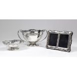 George V silver circular rose bowl with pierced rim and moulded body, the scroll handles cast with