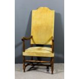 A walnut framed high back open armchair of 18th Century design, with arched cresting, the seat and