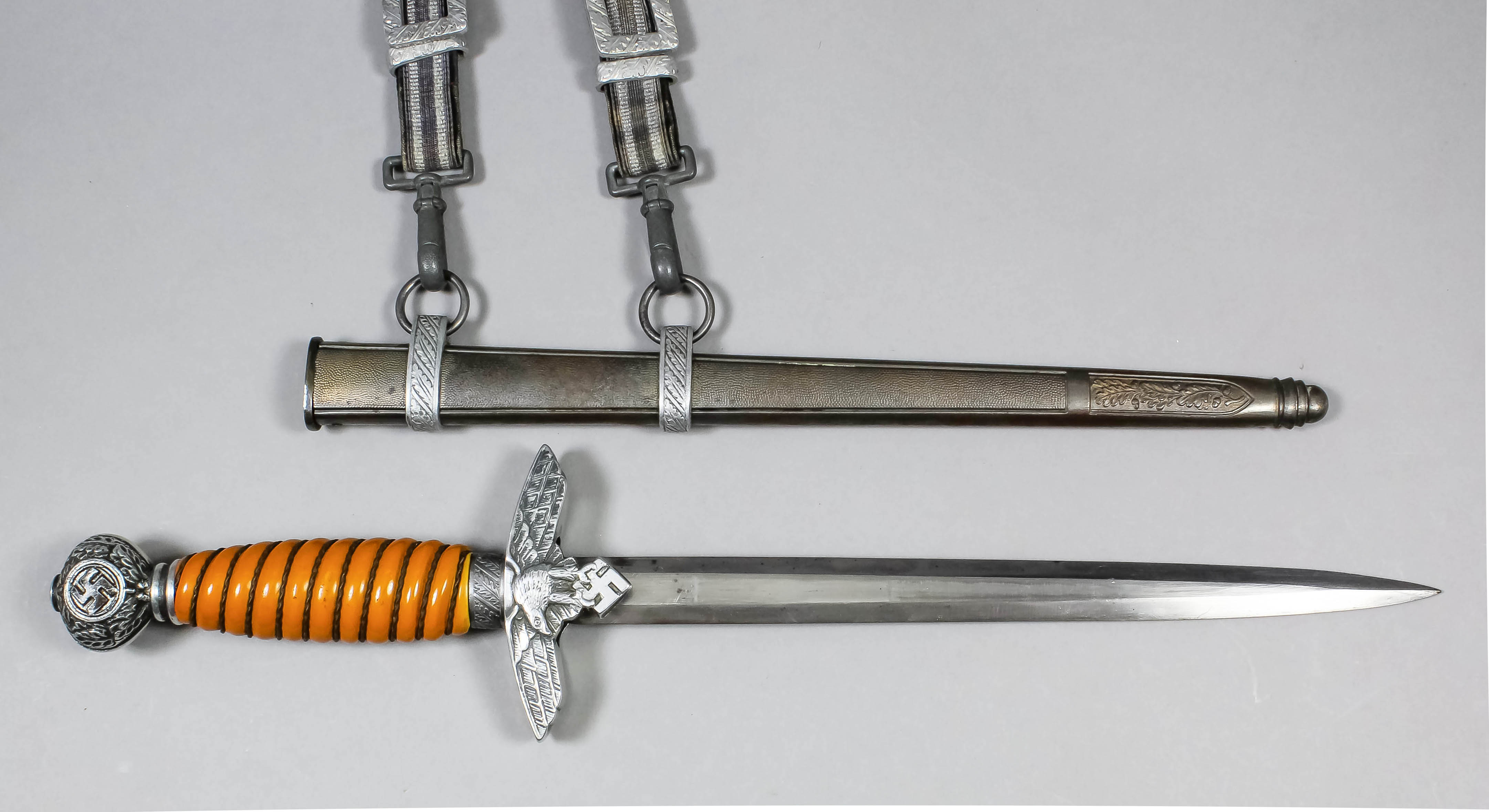 A German World War II Army dress dagger, the 9.5ins double edged bright steel blade etched "
