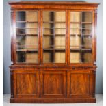 An early Victorian mahogany three door bookcase, the upper part with moulded cornice, fitted six