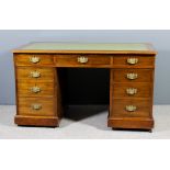 A Victorian mahogany kneehole desk with later green tooled leather inset to top, fitted nine drawers