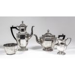 A George V silver three piece tea and coffee service of octagonal panelled form, with turned finials