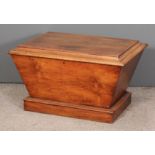 An early Victorian walnut rectangular cellaret of sarcophagus shape, the flat top enclosing lined