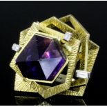 A modern 18k gold mounted amethyst and diamond ring, the asymmetrically cut amethyst within three