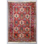A Bakhtiari rug woven in colours with three rows, each with five shaped medallions filled with bids,