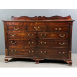 A George III mahogany mule chest with shaped upstand and lifting lid, fitted five dummy and four