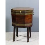 A George III mahogany and brass bound octagonal two handled wine cooler on stand with square tapered