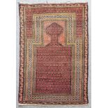 A Baluch prayer rug, woven in muted shades, the central trellis design filled with geometric motifs,