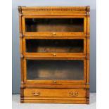 An early 20th Century Globe Wernicke panelled oak three-tier bookcase, the upper tier with moulded