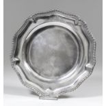 A mid-18th Century silver plate of shaped outline, with gadroon mounts to rim, 9.5ins diameter, by