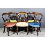 A set of six Victorian mahogany dining chairs with shaped and moulded backs, splats pierced and