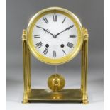 A brass cased mantel clock, the 6.75ins diameter white enamel dial with Roman numerals, inscribed "