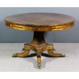 A George IV rosewood and brass inlaid circular breakfast table, the figured veneered top inlaid with