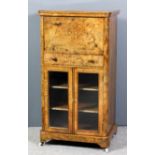 A late Victorian figured walnut Secretaire music cabinet with rounded front corners, the whole