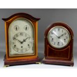 An early 20th Century German stained as mahogany cased mantel clock, the 7.5ins arched silvered dial