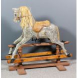 An early 20th Century childs carved and grey painted rocking horse on stand, 38ins high x 38ins