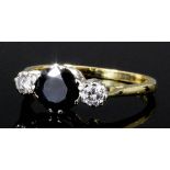 A modern 18ct gold mounted sapphire and diamond ring, the central sapphire of approximately .50ct,