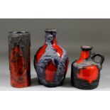 A German "Fat Lava" red glazed cylindrical vase, 8ins high, a similar ovoid vase, 8.75ins high,