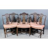 A set of six George III mahogany dining chairs, (including two armchairs) of "Hepplewhite" design,