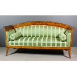 A 19th Century Continental fruitwood three seat settee in the "Biedermeier" style, with slightly