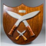 A 20th Century mahogany presentation plaque in the form of a shield, mounted with two British Army