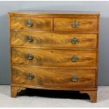 A late George III mahogany bow-front chest with twin reeded edge to top, fitted two short and