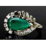 A 1960s silvery coloured metal mounted emerald and diamond ring, the pear shaped emerald