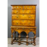 An 18th Century walnut chest on stand, the whole cross-banded, the upper part with moulded