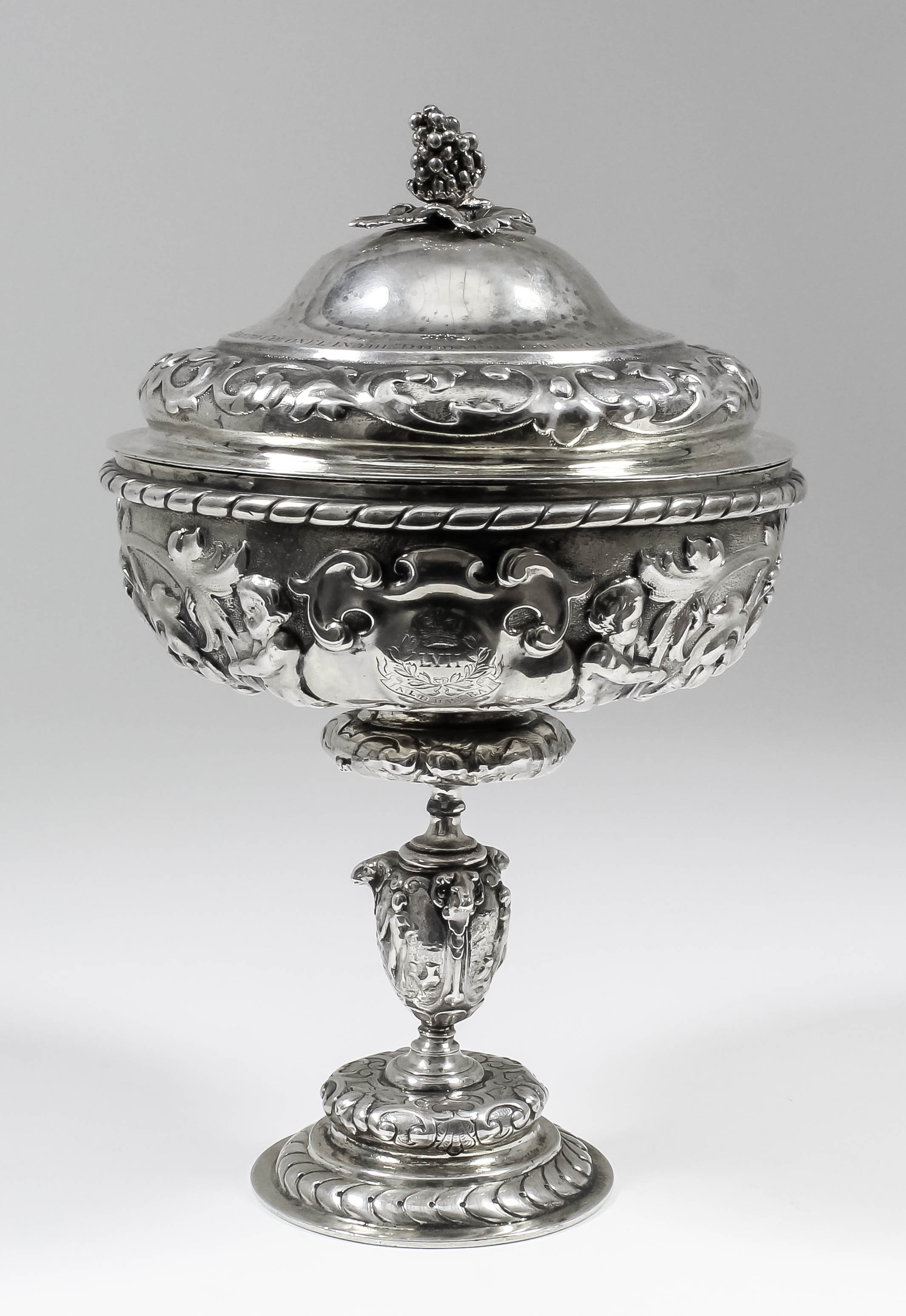 A Victorian Regimental silver gilt cup and cover of Mannerist design, the whole cast with scroll