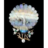 An early 20th Century gold coloured metal mounted boulder opal peacock pattern brooch, the stone