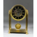 A brass cased mantel clock, the 5ins diameter black slate chapter ring with gilt Roman numerals