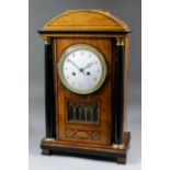 An early 19th Century Continental walnut and ebonised mantel clock in the "Biedermeier" style, the