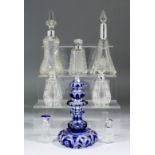 A late 19th Century blue overlay cut glass scent bottle and stopper, 6.75ins high, together with