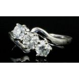 A modern 18ct white gold mounted three stone diamond crossover ring, the central brilliant cut stone